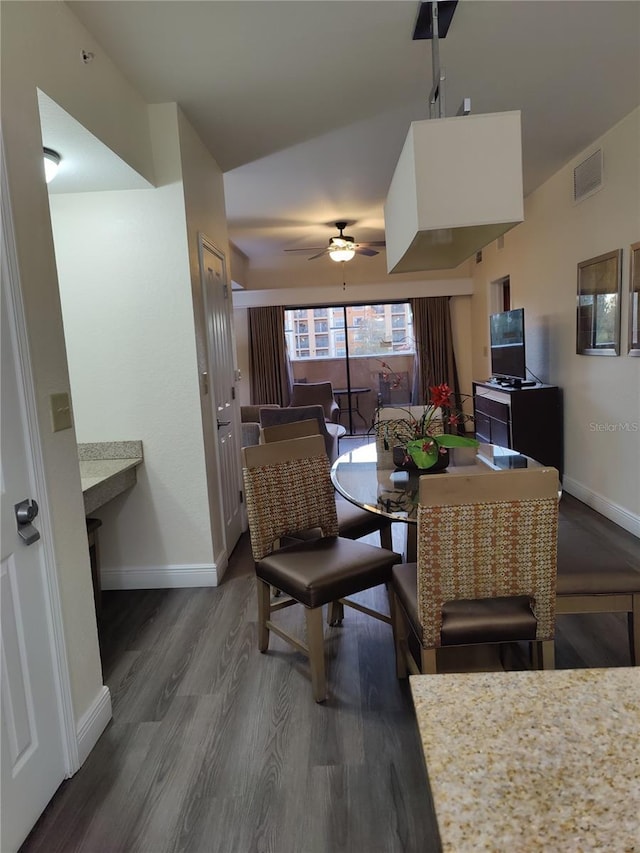 dining space featuring ceiling fan and dark wood-type flooring