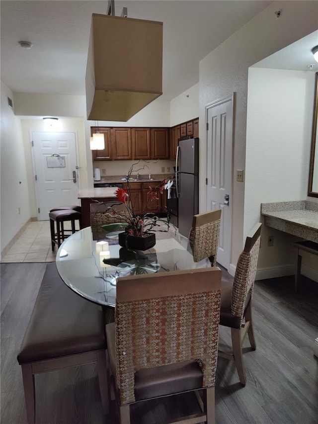 dining room featuring light hardwood / wood-style flooring and sink