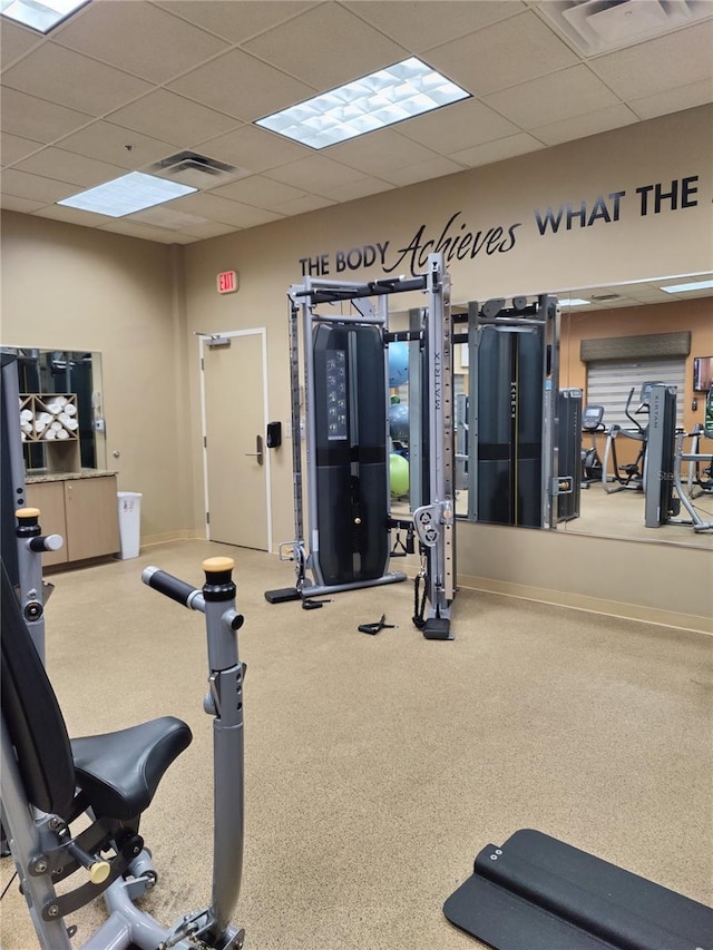 exercise room with a paneled ceiling