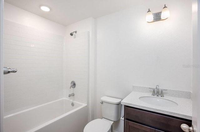 full bathroom with vanity, tiled shower / bath combo, and toilet