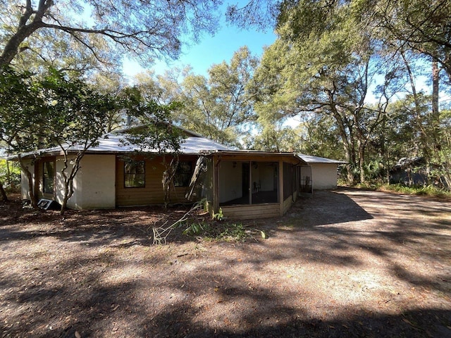 rear view of house with a sunroom