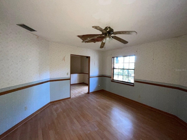 unfurnished room featuring hardwood / wood-style floors and ceiling fan