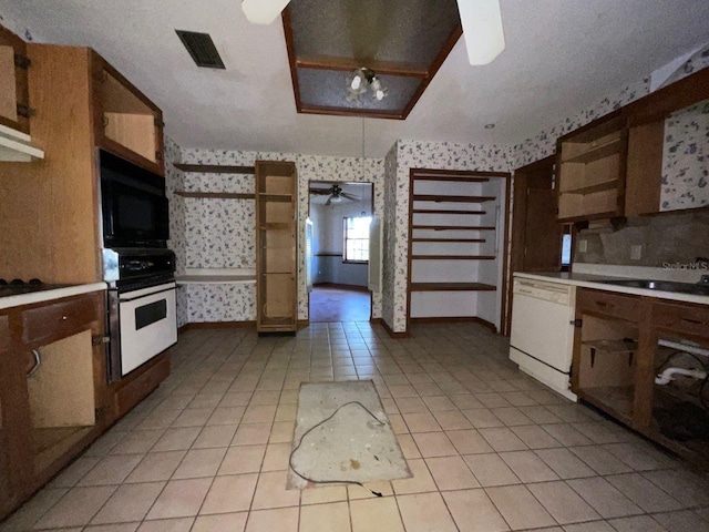 kitchen with white dishwasher, ceiling fan, sink, oven, and light tile patterned flooring