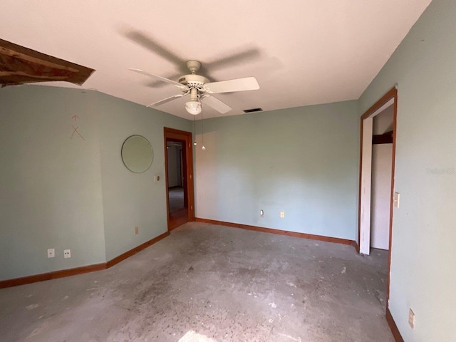 empty room with ceiling fan and concrete floors