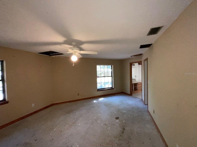 unfurnished room featuring ceiling fan and concrete floors