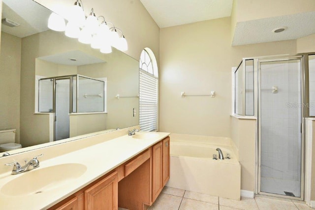 bathroom with a stall shower, a sink, and tile patterned floors