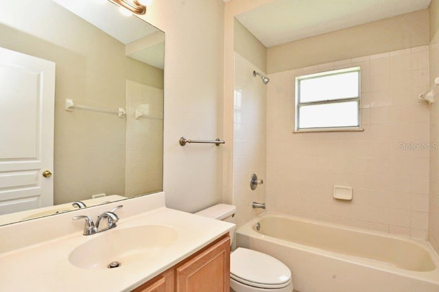 bathroom with shower / bath combination, vanity, and toilet