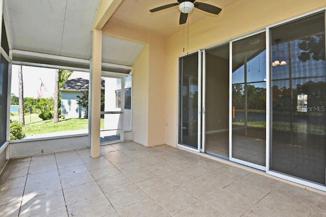 unfurnished sunroom with a healthy amount of sunlight and ceiling fan