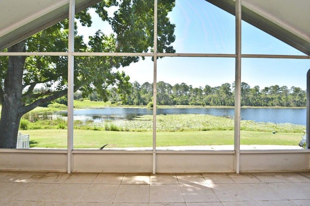 unfurnished sunroom featuring a water view and a wealth of natural light