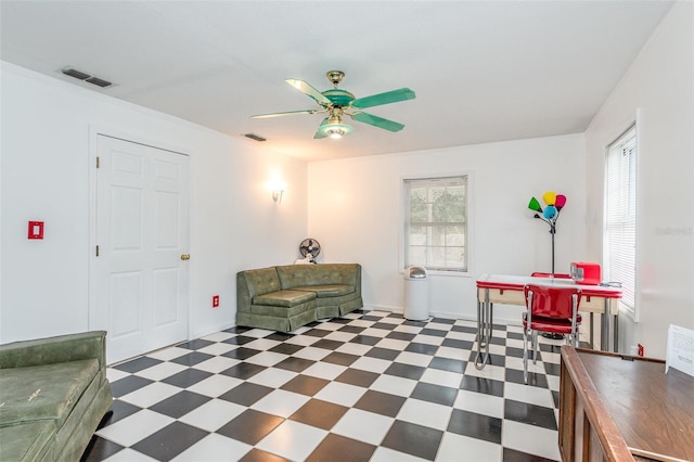 living area with ceiling fan