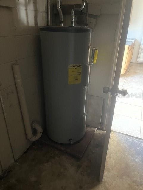 utility room featuring water heater