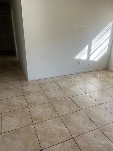 empty room with light tile patterned floors