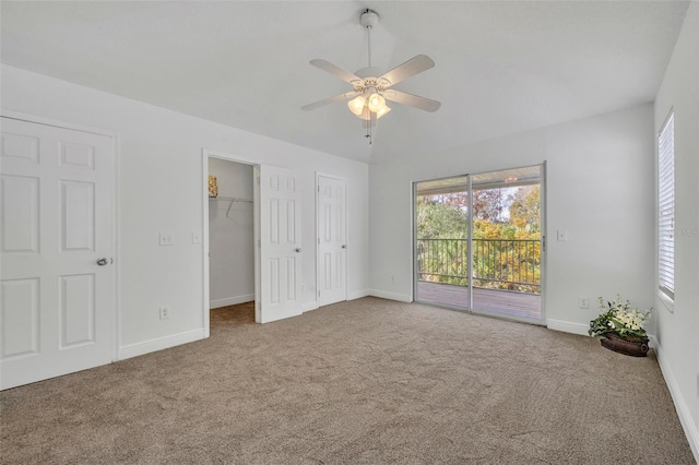 unfurnished bedroom with access to outside, ceiling fan, and carpet