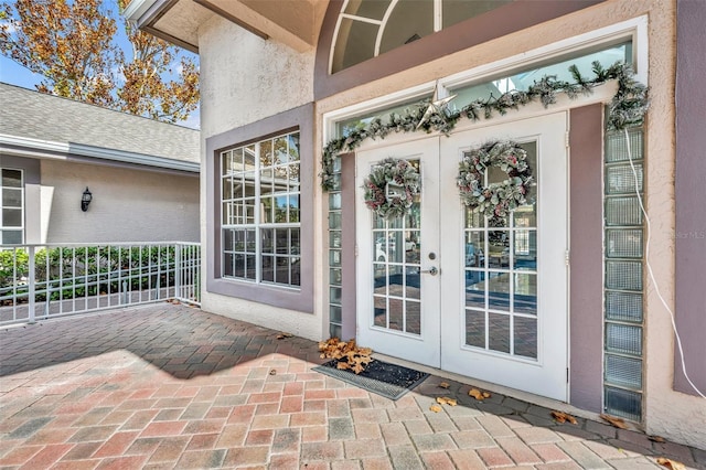 view of exterior entry featuring french doors