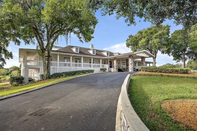 view of front of house with covered porch and a front yard