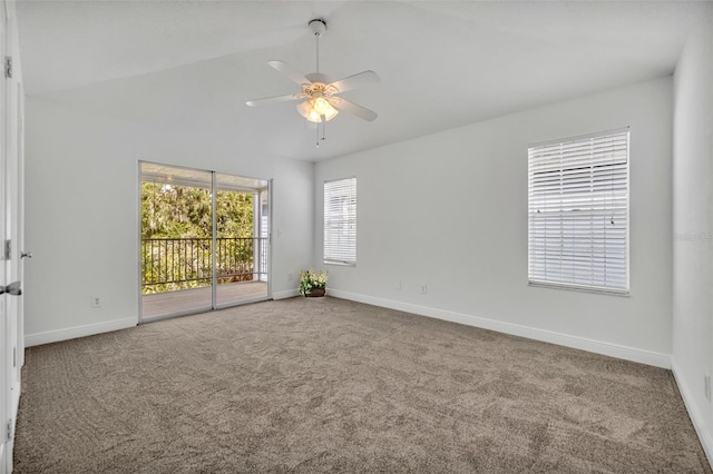 empty room featuring carpet flooring, ceiling fan, baseboards, and vaulted ceiling