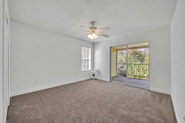 unfurnished room featuring baseboards, carpet, ceiling fan, and a textured ceiling