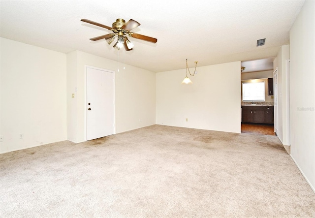 spare room with ceiling fan, carpet, and a textured ceiling