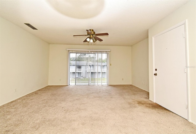 spare room with light colored carpet and ceiling fan