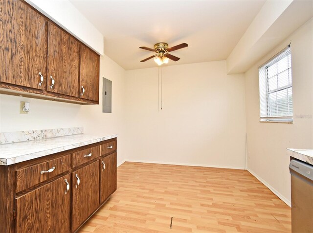 kitchen with electric panel, ceiling fan, light hardwood / wood-style floors, and stainless steel dishwasher