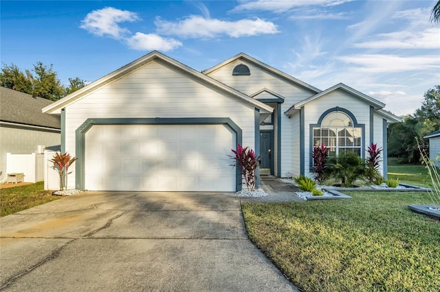 ranch-style house with a garage and a front lawn