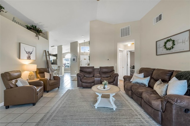 living room featuring light tile patterned floors and high vaulted ceiling