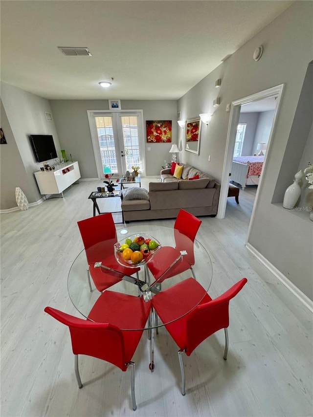 living room featuring light wood-type flooring and french doors