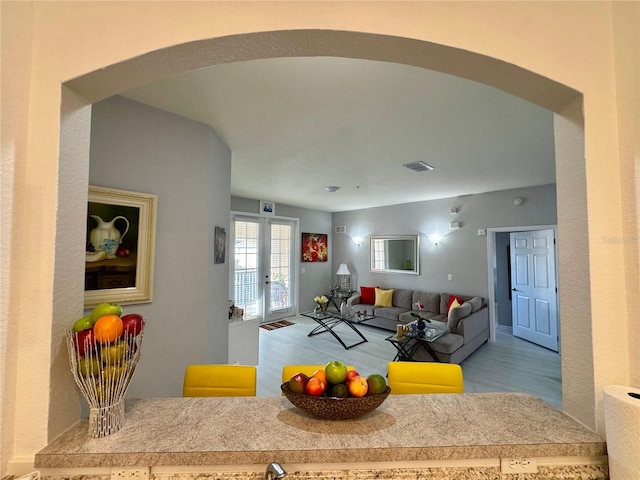 living room with light hardwood / wood-style floors and french doors