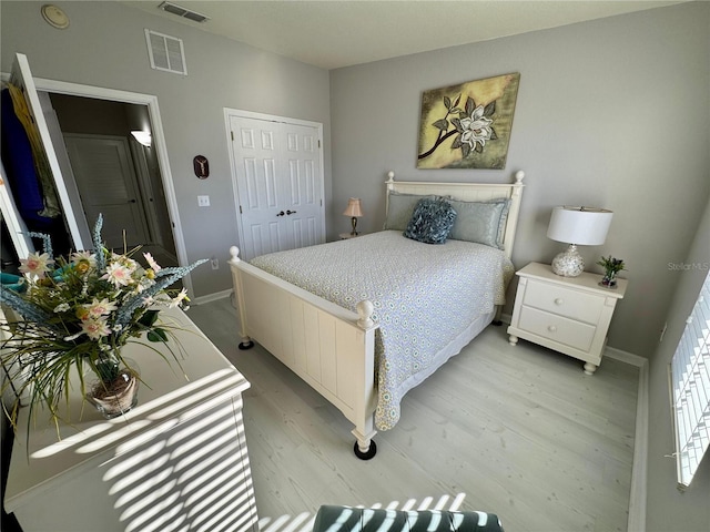 bedroom with a closet and light hardwood / wood-style flooring