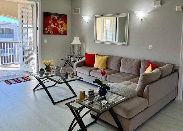 living room with light hardwood / wood-style floors and a wealth of natural light