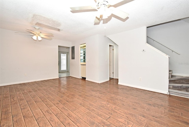 unfurnished living room with ceiling fan, a textured ceiling, and hardwood / wood-style flooring