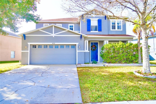 view of front facade with a front yard and a garage