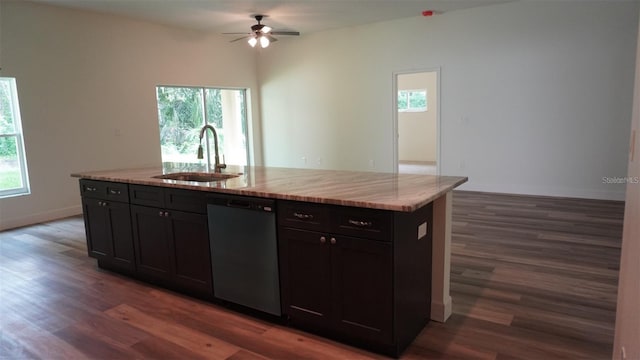 kitchen with plenty of natural light, dishwasher, and a center island with sink