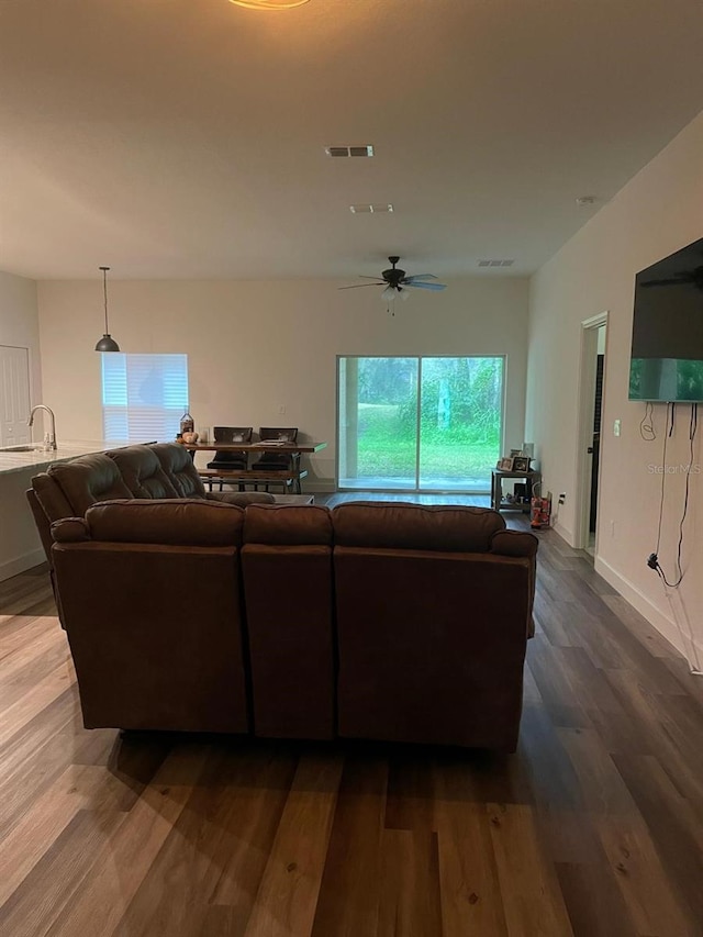 living room featuring hardwood / wood-style floors and ceiling fan