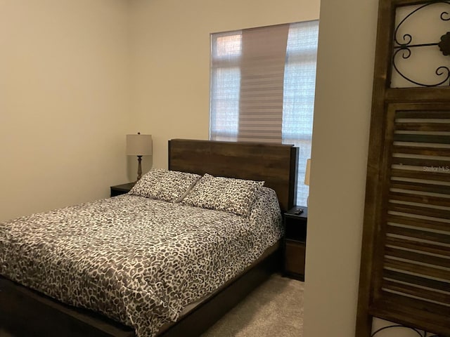 bedroom featuring light colored carpet