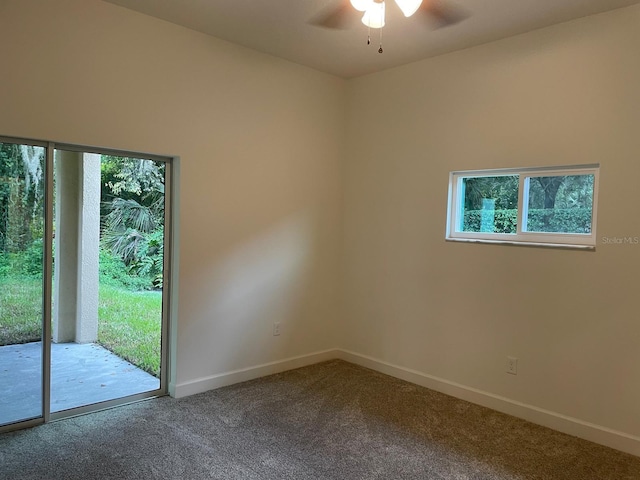 carpeted spare room featuring ceiling fan