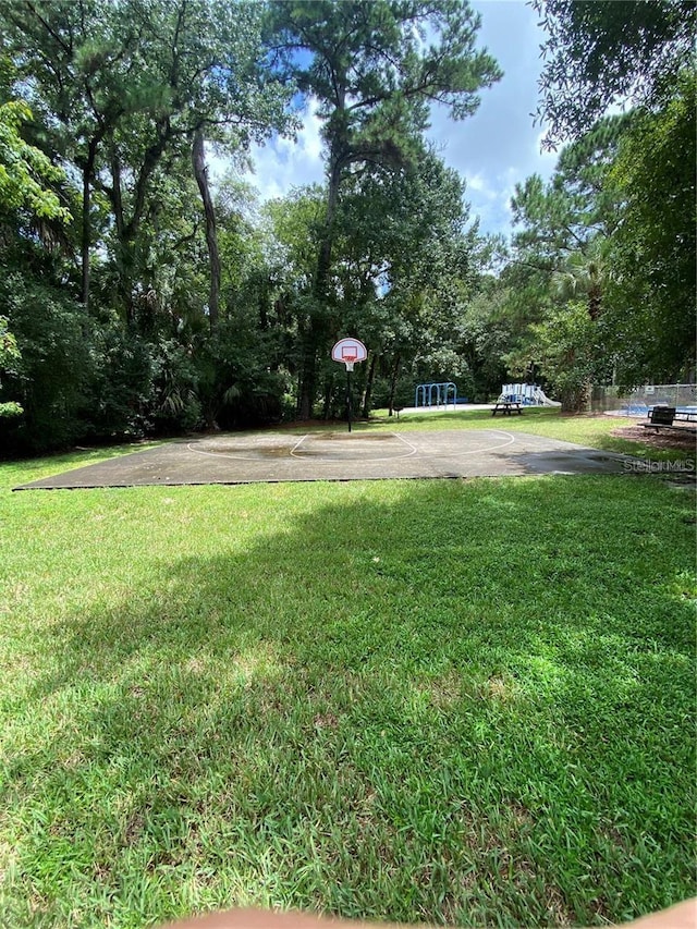 view of yard with basketball hoop