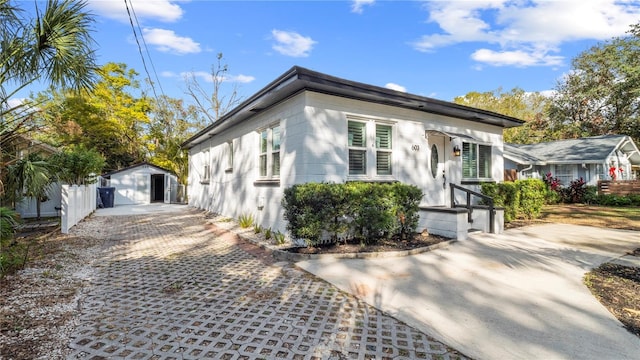 view of front of home featuring a garage and an outdoor structure