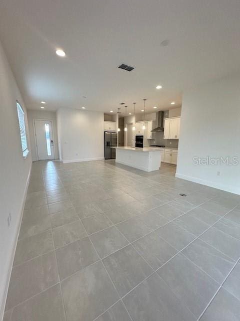 unfurnished living room with light tile patterned floors