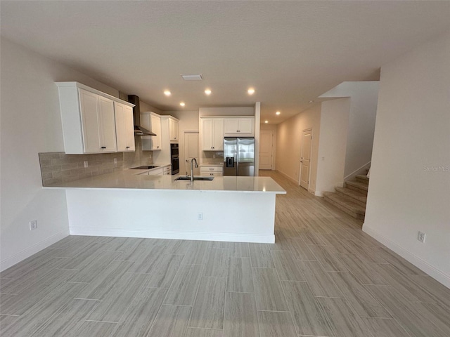 kitchen featuring white cabinetry, sink, kitchen peninsula, and black appliances