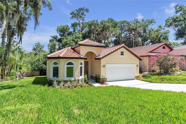 mediterranean / spanish home with a front lawn and a garage