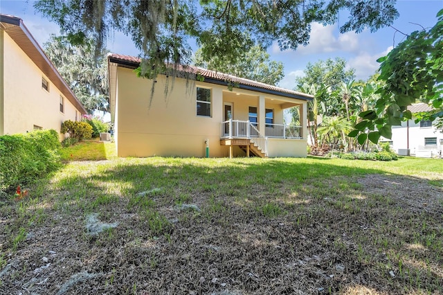 rear view of property with a lawn