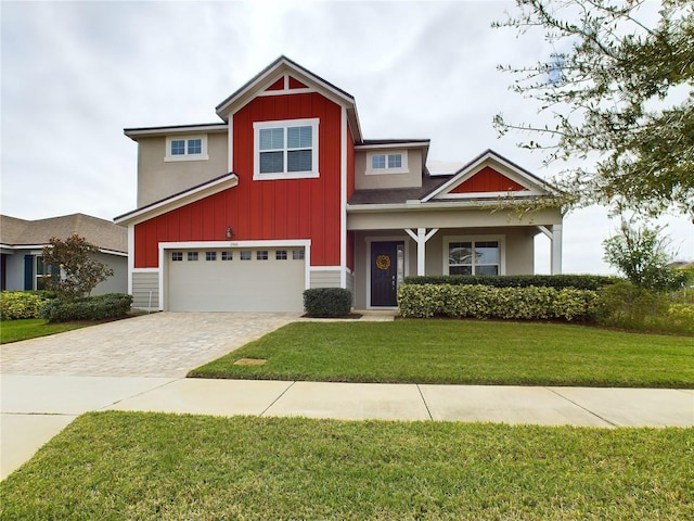 view of front of house with a garage and a front lawn