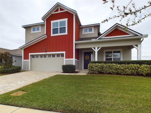 craftsman-style house featuring a garage and a front lawn