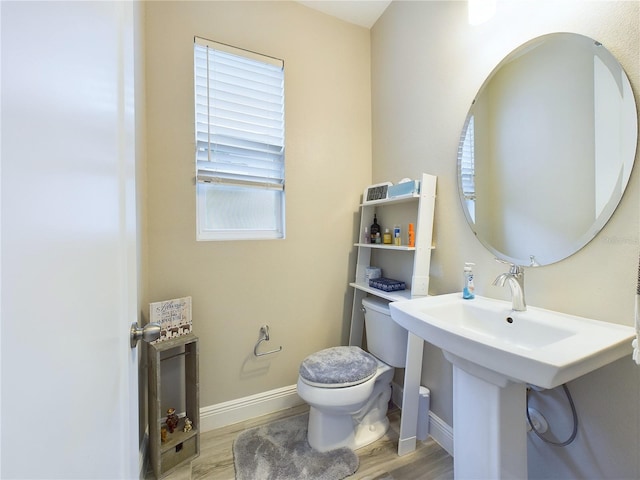 bathroom with hardwood / wood-style floors, toilet, and a wealth of natural light