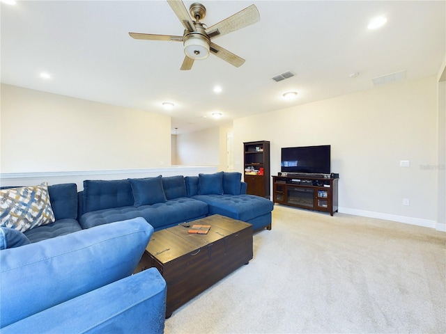 carpeted living room featuring ceiling fan