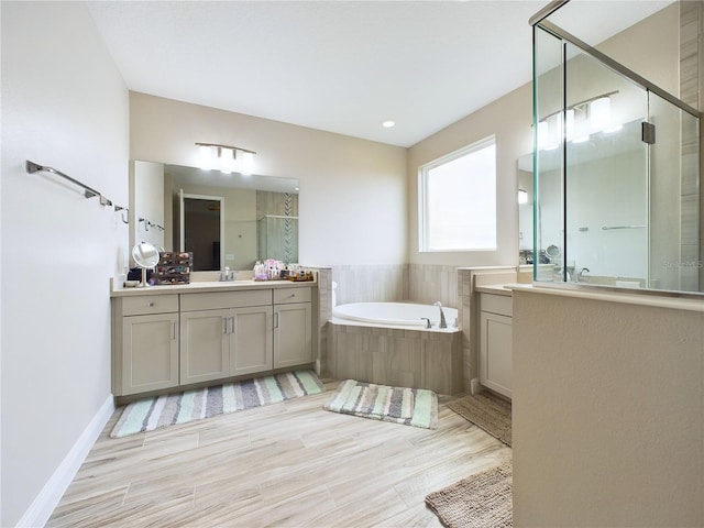 bathroom with vanity and independent shower and bath