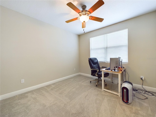 carpeted office space with ceiling fan