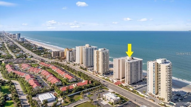 birds eye view of property with a water view and a view of the beach