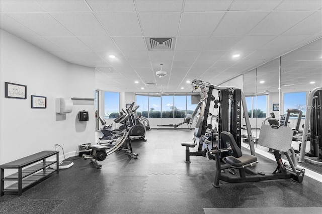 gym with a paneled ceiling